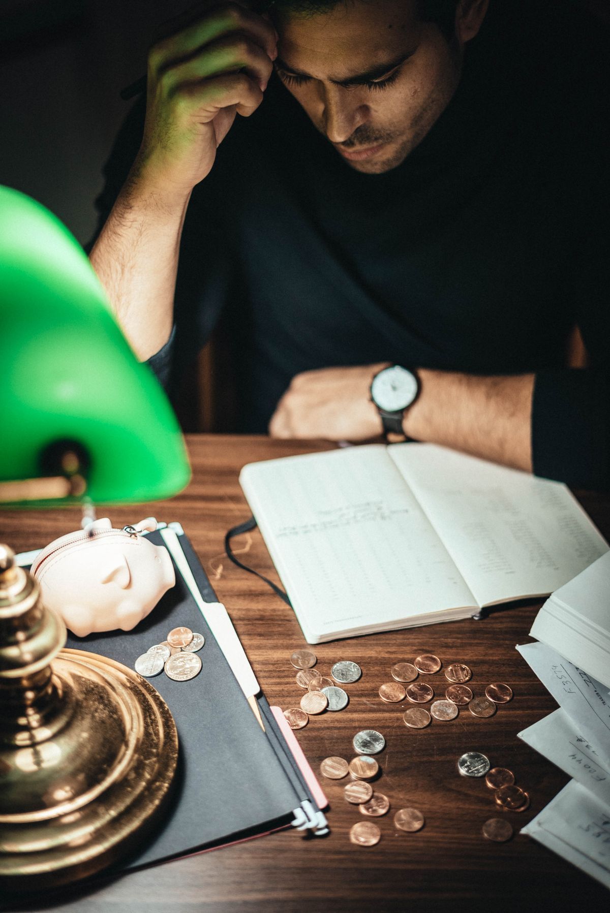 A business owner going through bills at their desk after hours.