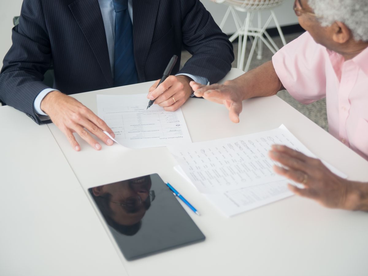 An advisor reviewing a funding application with a business owner.